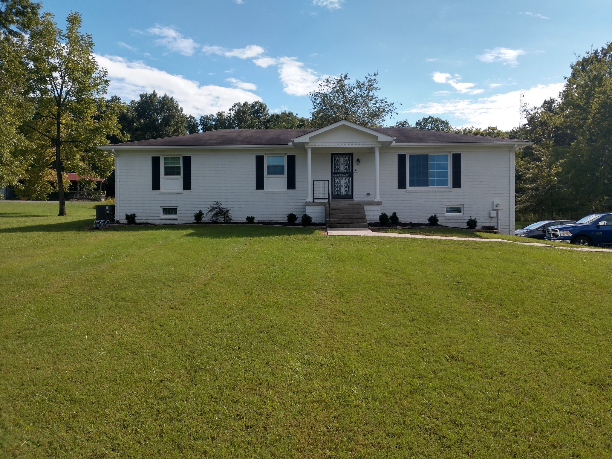 a front view of house with yard and trees