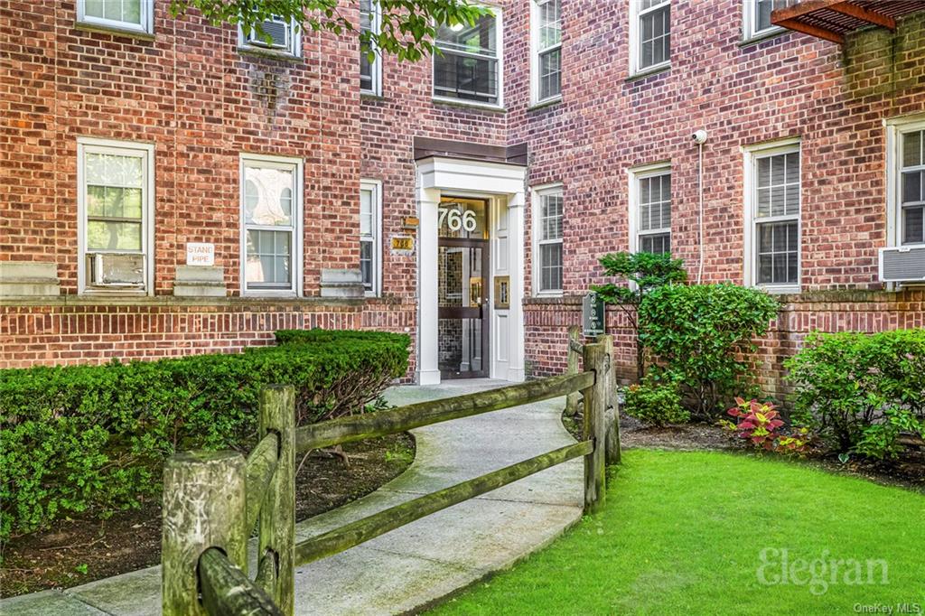 View of exterior entry with a lawn