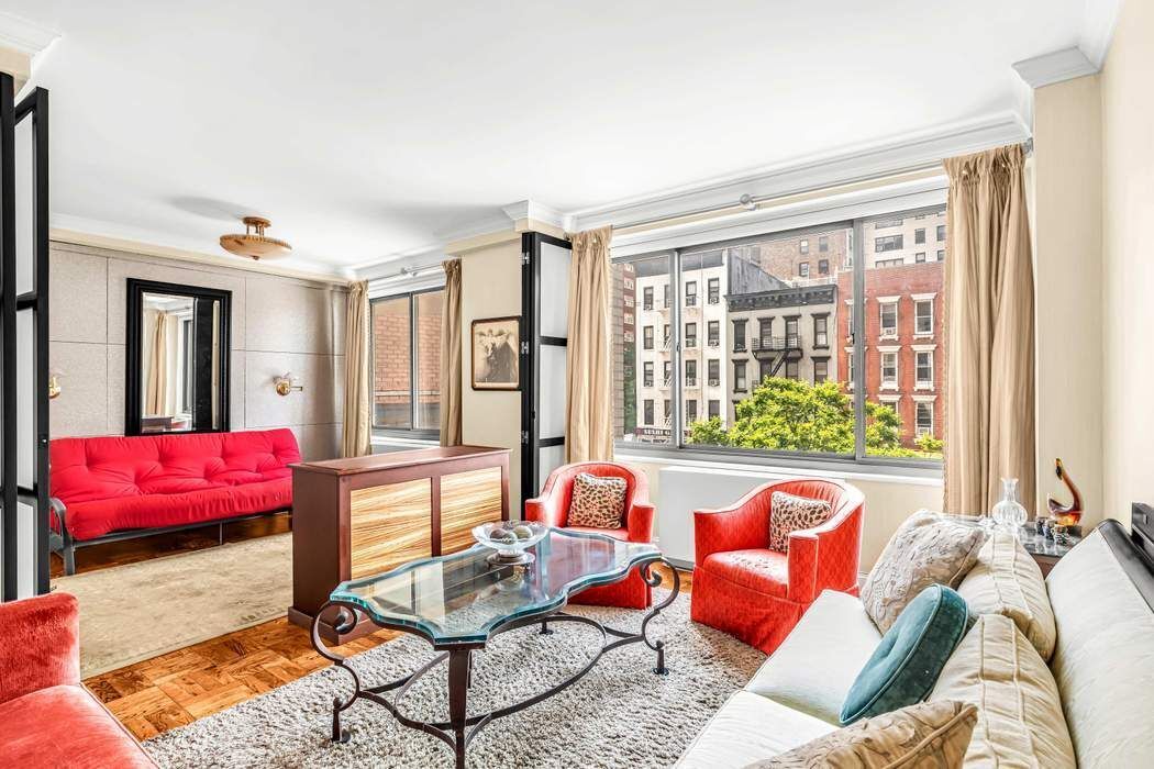 a living room filled with furniture and a large window