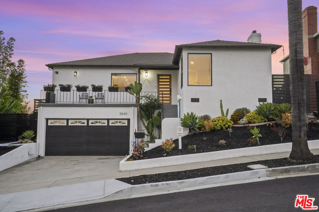 a front view of a house with a yard and a garage