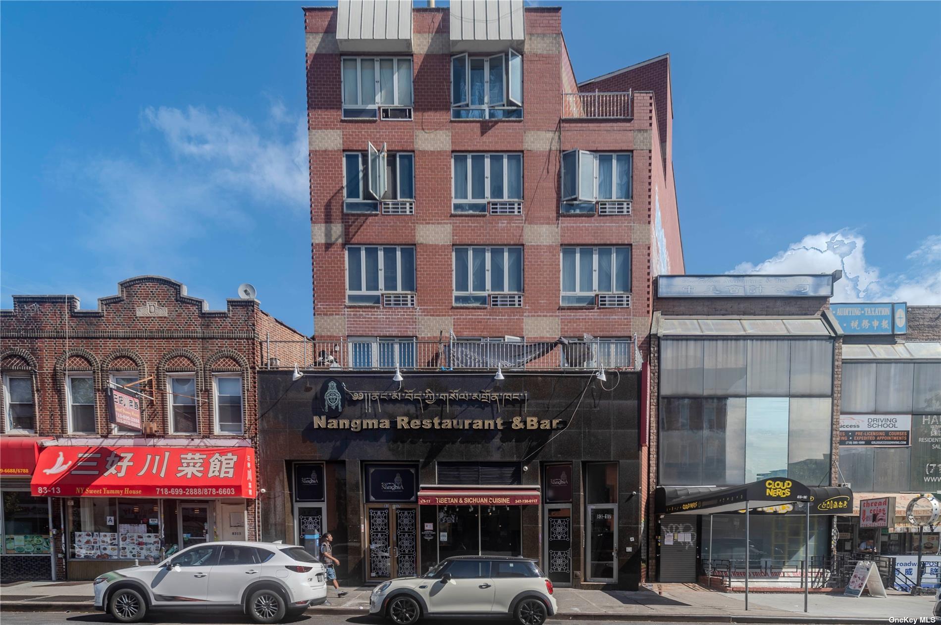 a front view of multi story residential apartment building with parking space