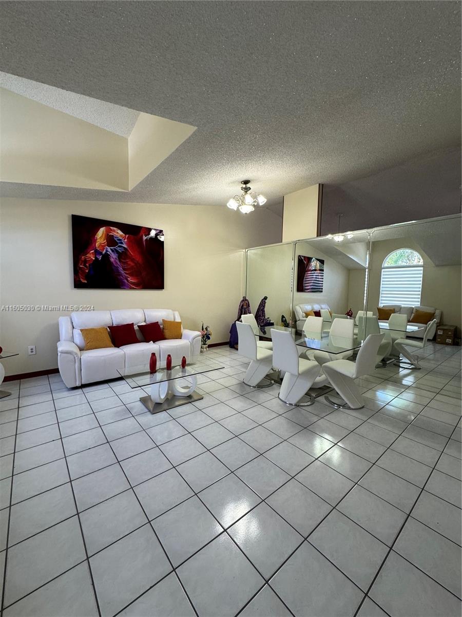 a living room with furniture and a lamp