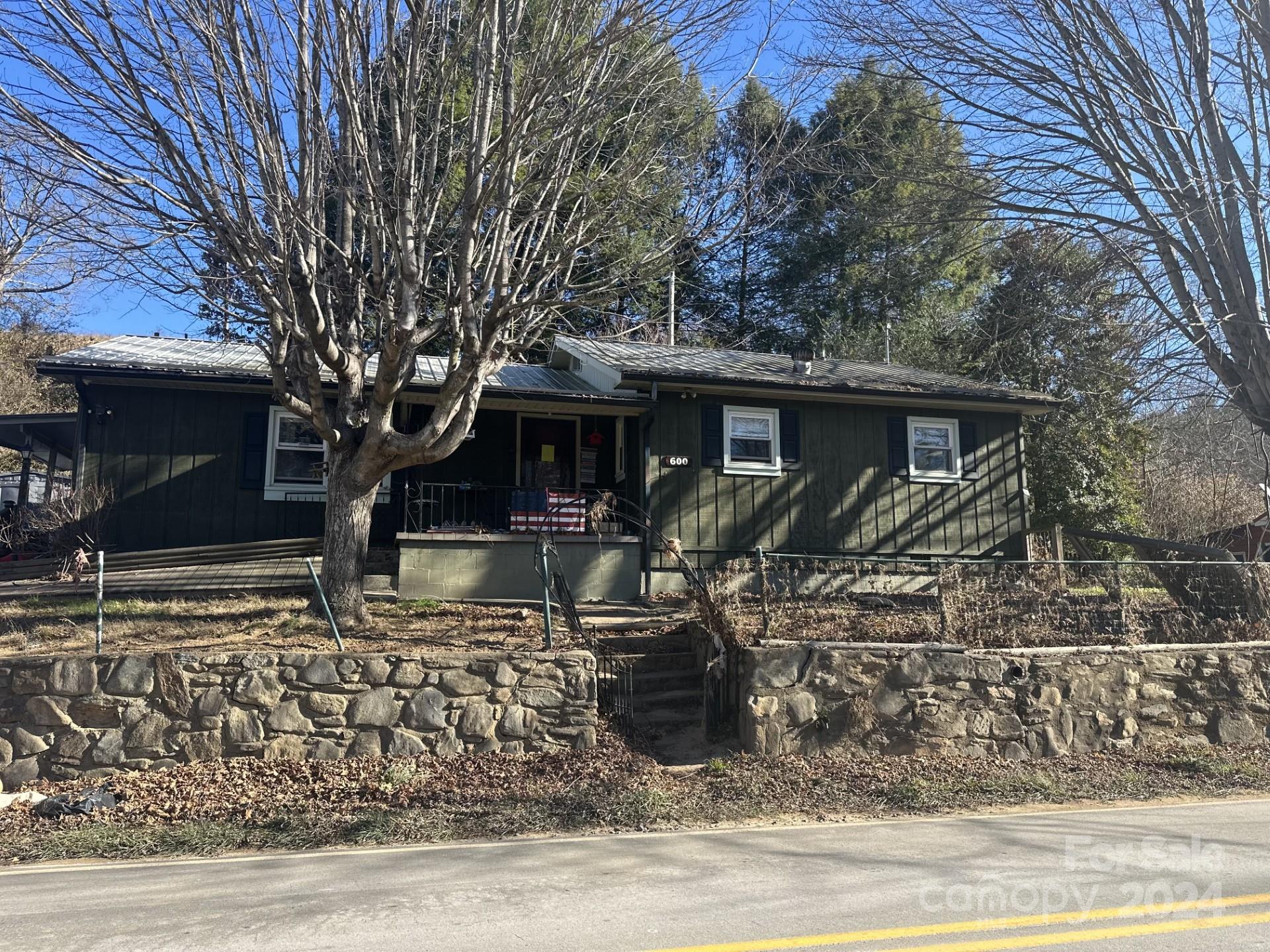 a view of a house with a large tree