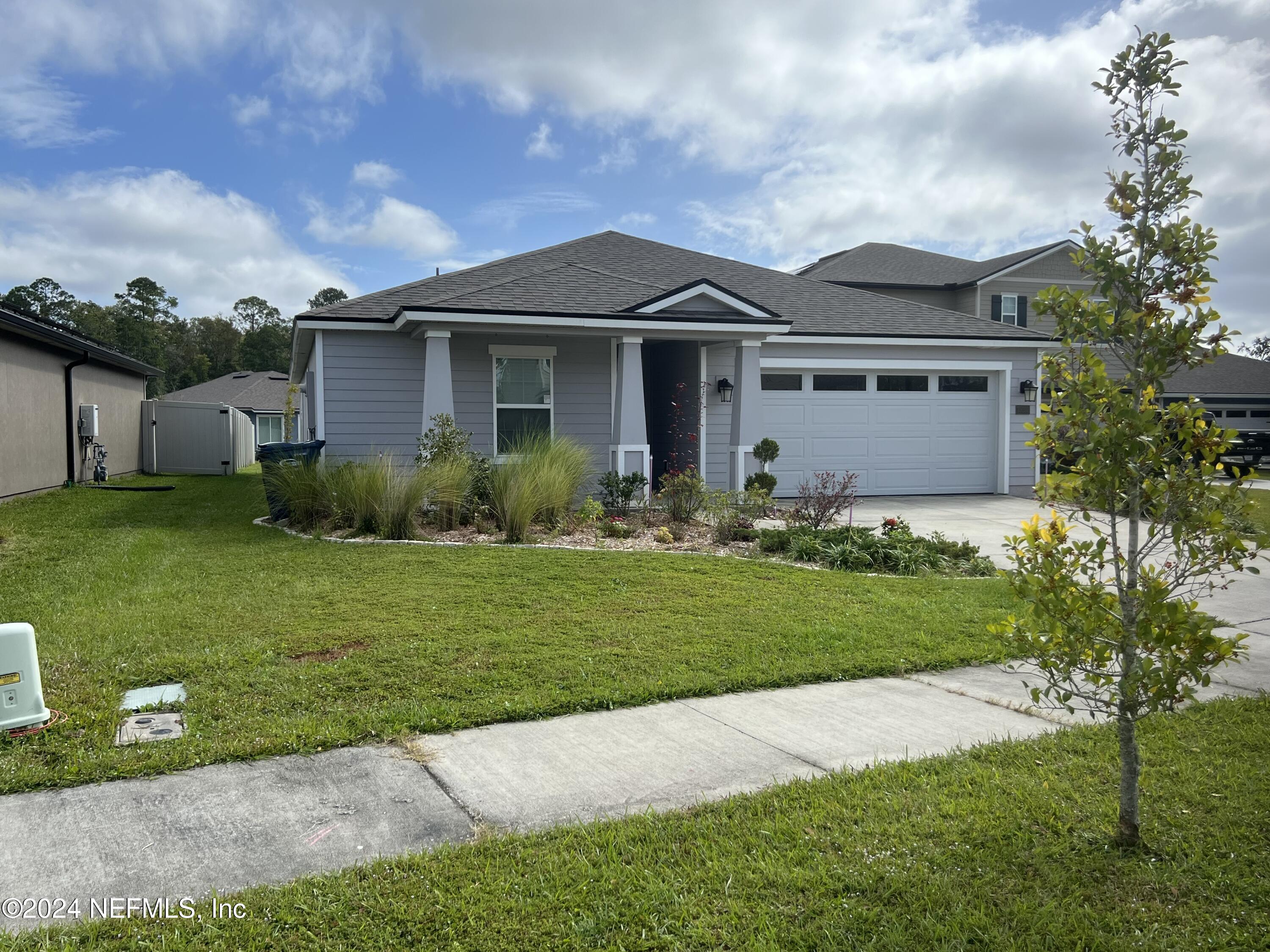 a front view of a house with garden