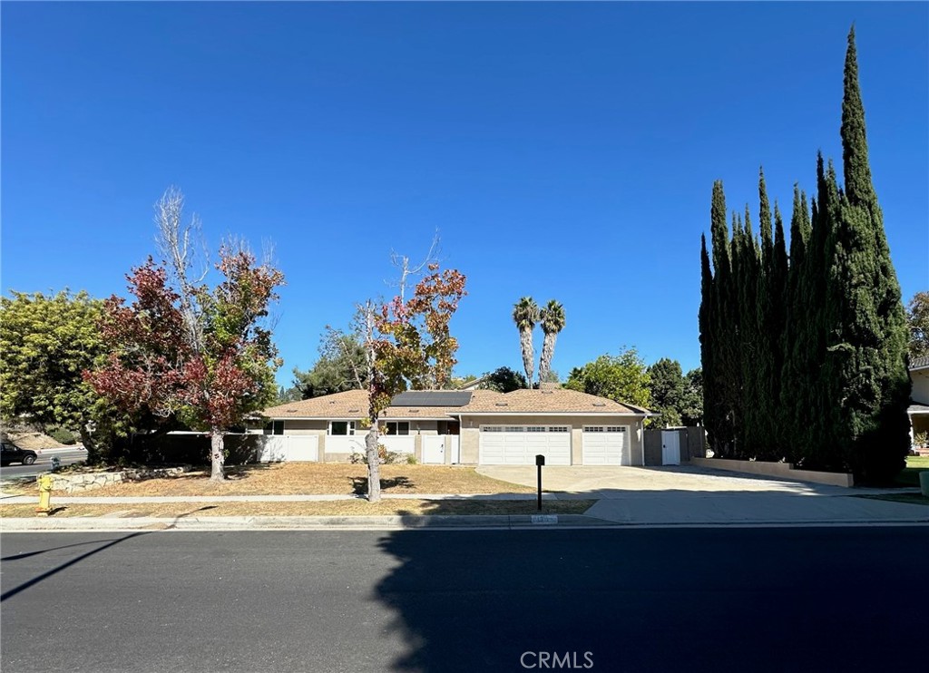 a view of a house with a yard and tree s