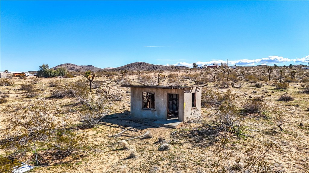 a view of a house with a yard and mountain view