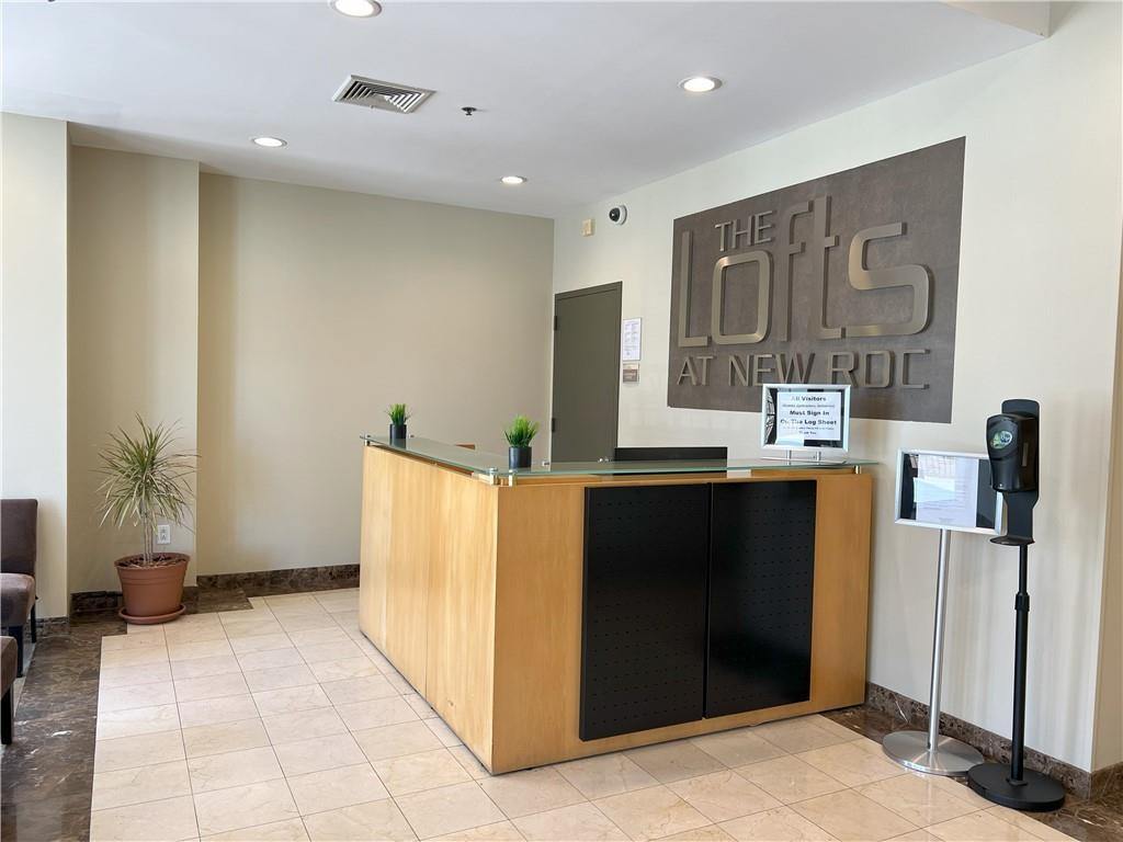 a kitchen with stainless steel appliances kitchen island granite countertop a refrigerator and a sink