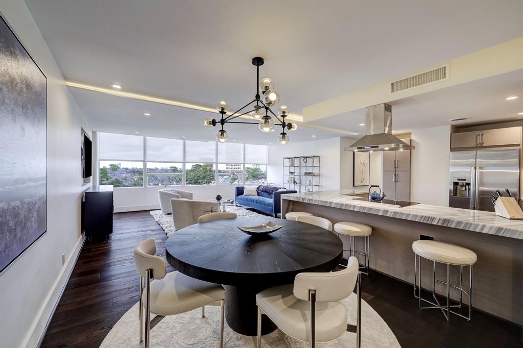 a kitchen with a table chairs stove and kitchen view