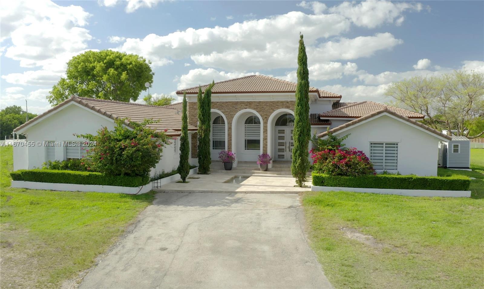 a front view of a house with garden