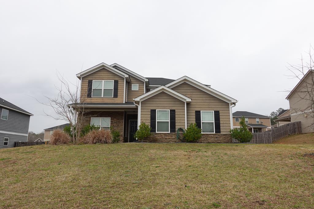 a front view of a house with a garden