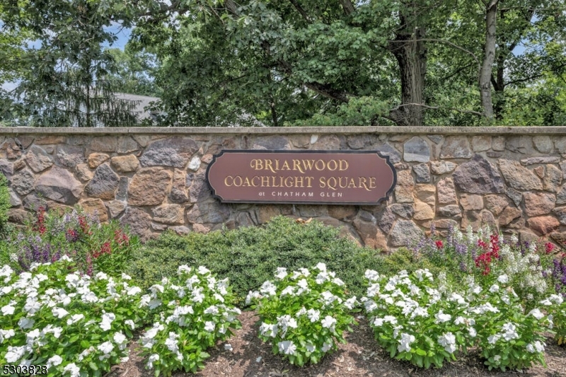 a view of sign board with yard and wooden fence