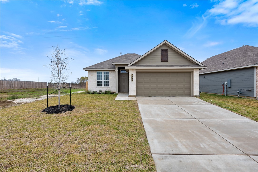 Ranch-style home with a front lawn and a garage