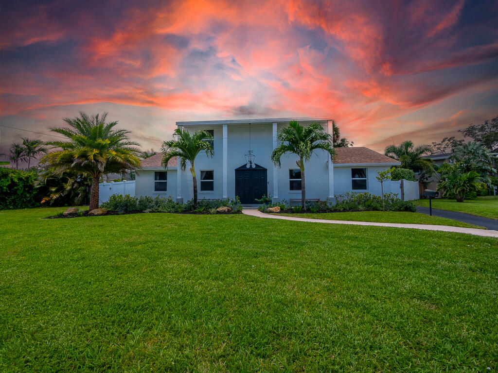 a view of an house with backyard space and garden