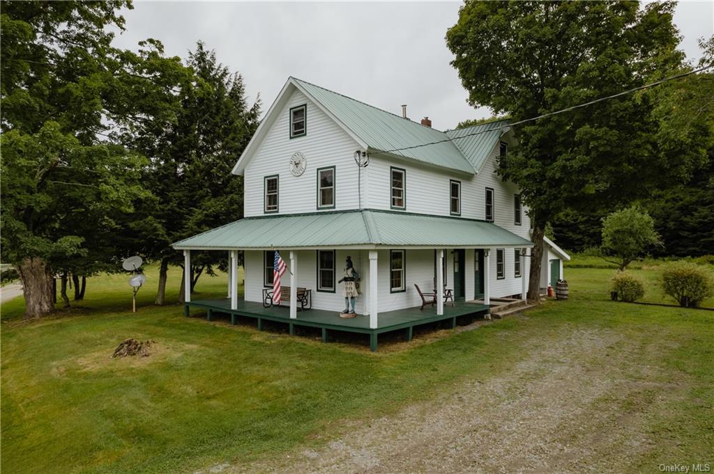 a view of a house with a yard porch and sitting area