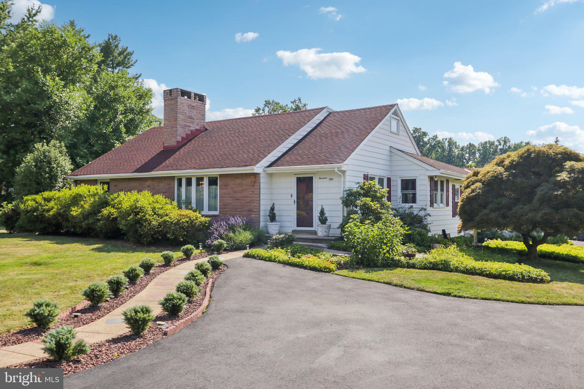 a front view of a house with a yard and outdoor seating