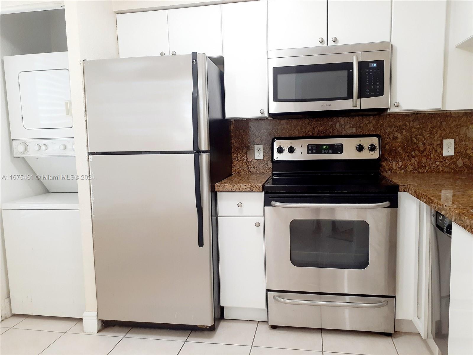 a white refrigerator freezer and a stove sitting inside of a kitchen