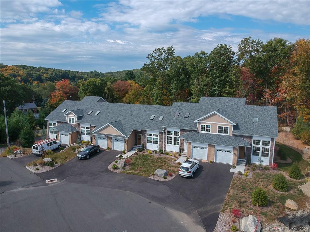 an aerial view of a house with garden space and street view