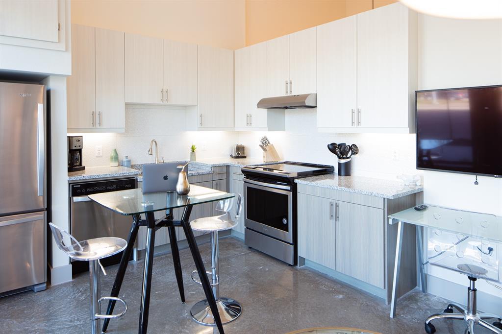 a kitchen with a stove a sink and a refrigerator