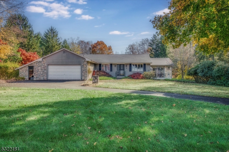 a view of a house with a big yard and large trees