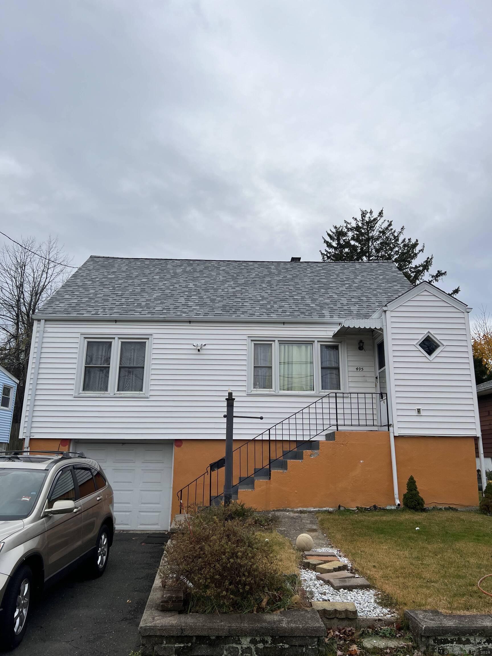 a front view of a house with a garden