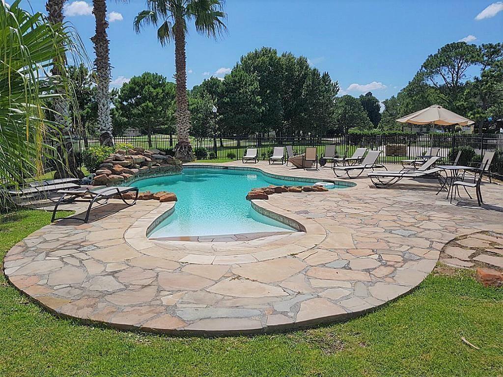 a view of a swimming pool with a table and chairs