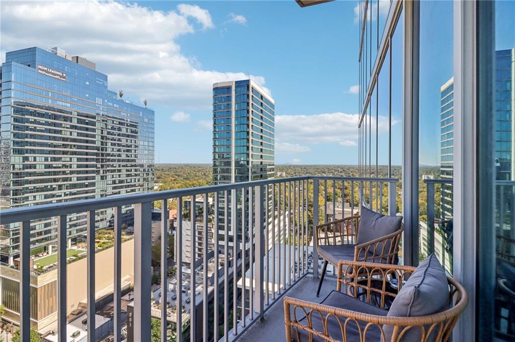 a balcony with a bench and city view