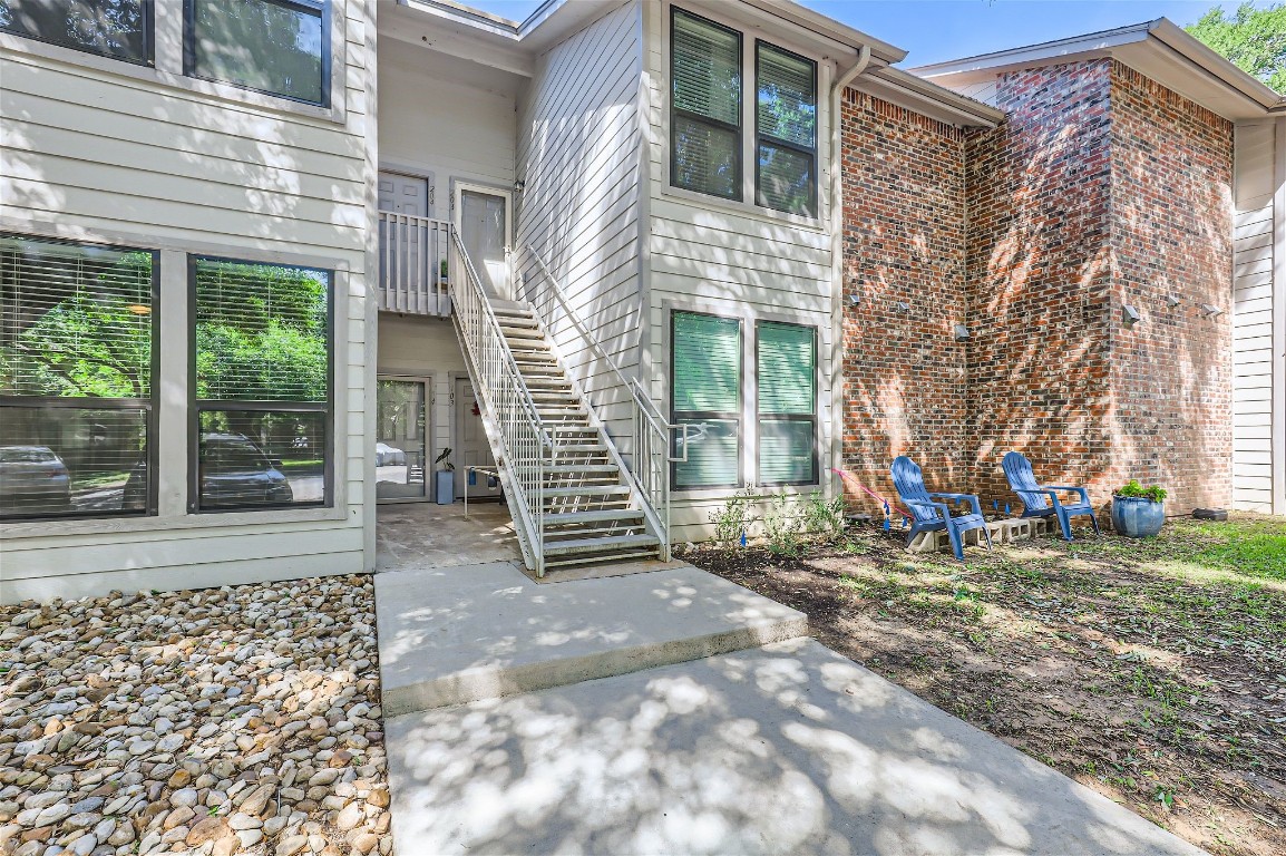 a view of a house with backyard porch and sitting area