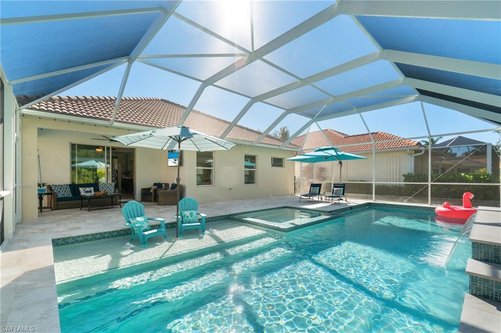 a patio with a table and chairs under an umbrella