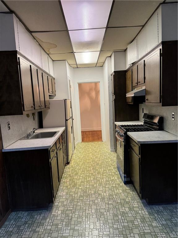 a kitchen with sink cabinets and stainless steel appliances