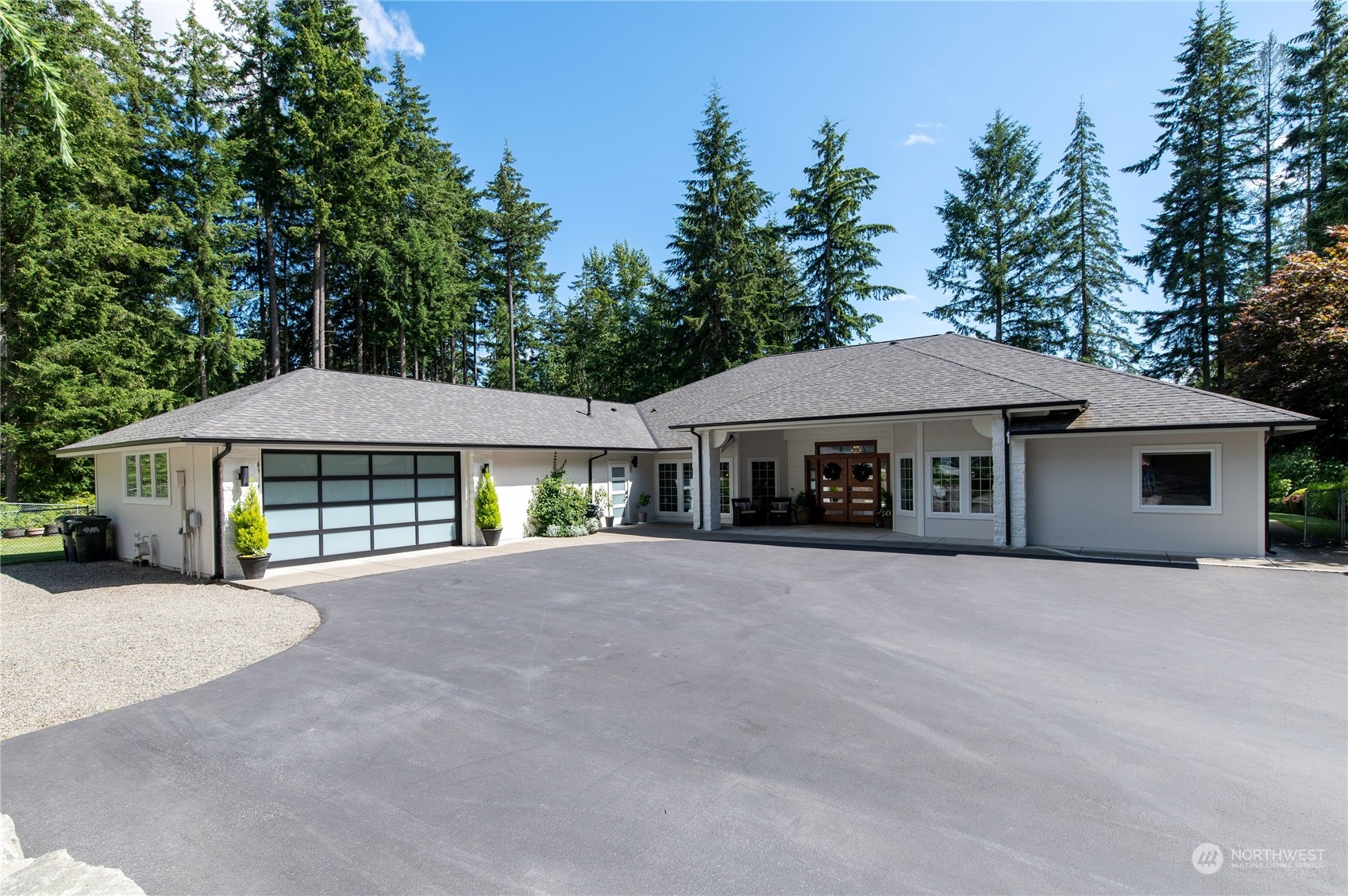 a front view of a house with yard and trees