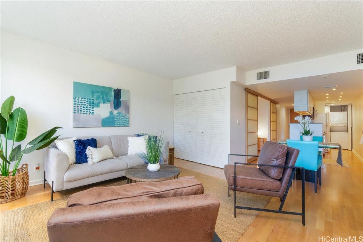 a living room with furniture and a potted plant