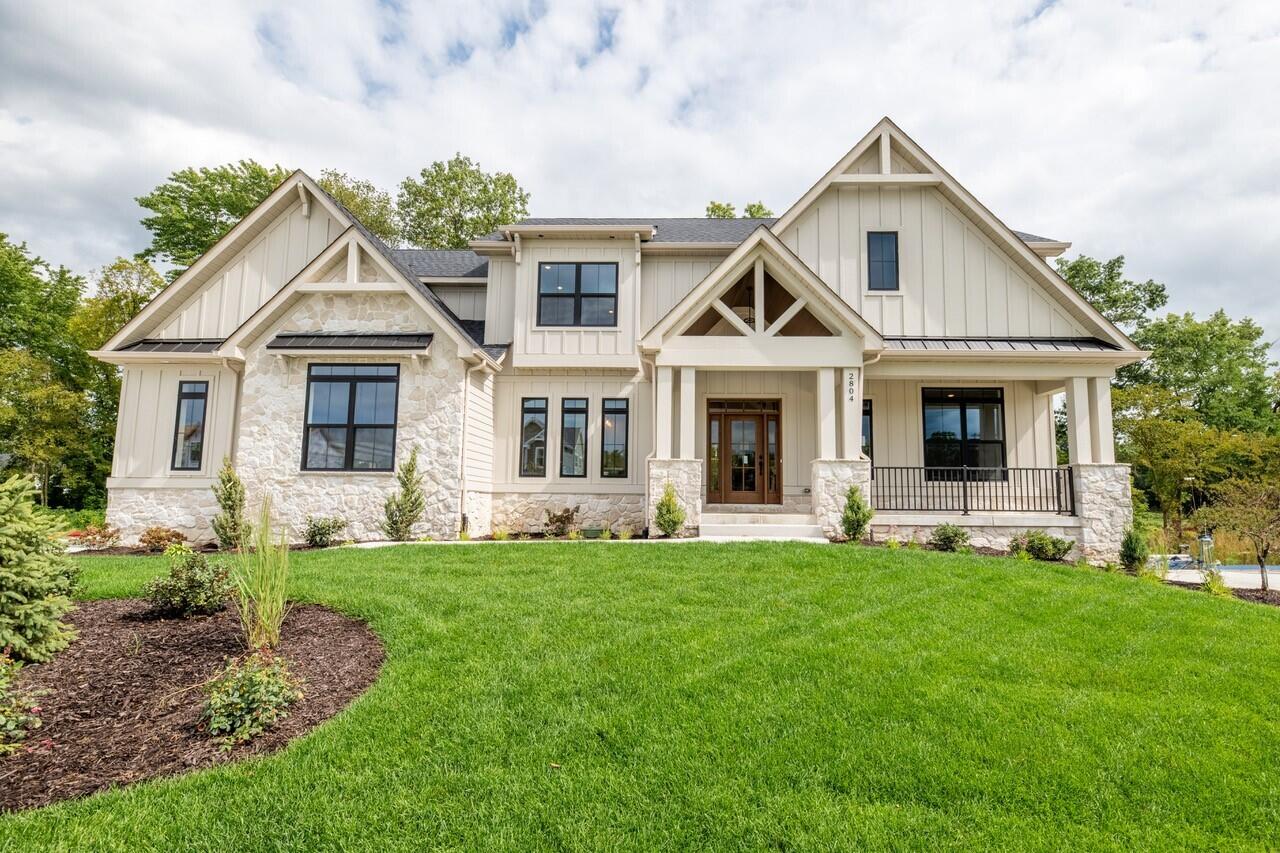 a front view of a house with a garden and yard