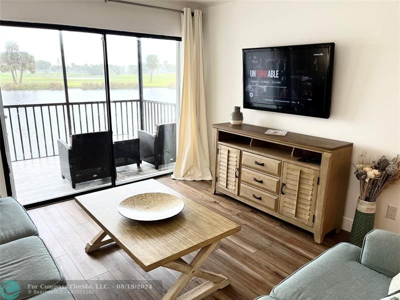 a living room with chairs and a flat screen tv