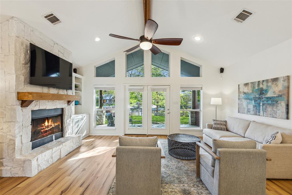 a living room with furniture a flat screen tv and a fireplace