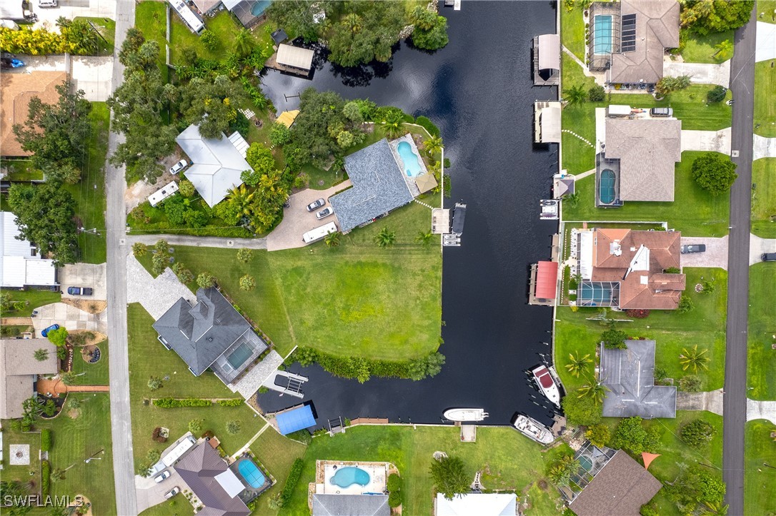 an aerial view of residential houses with outdoor space and street view