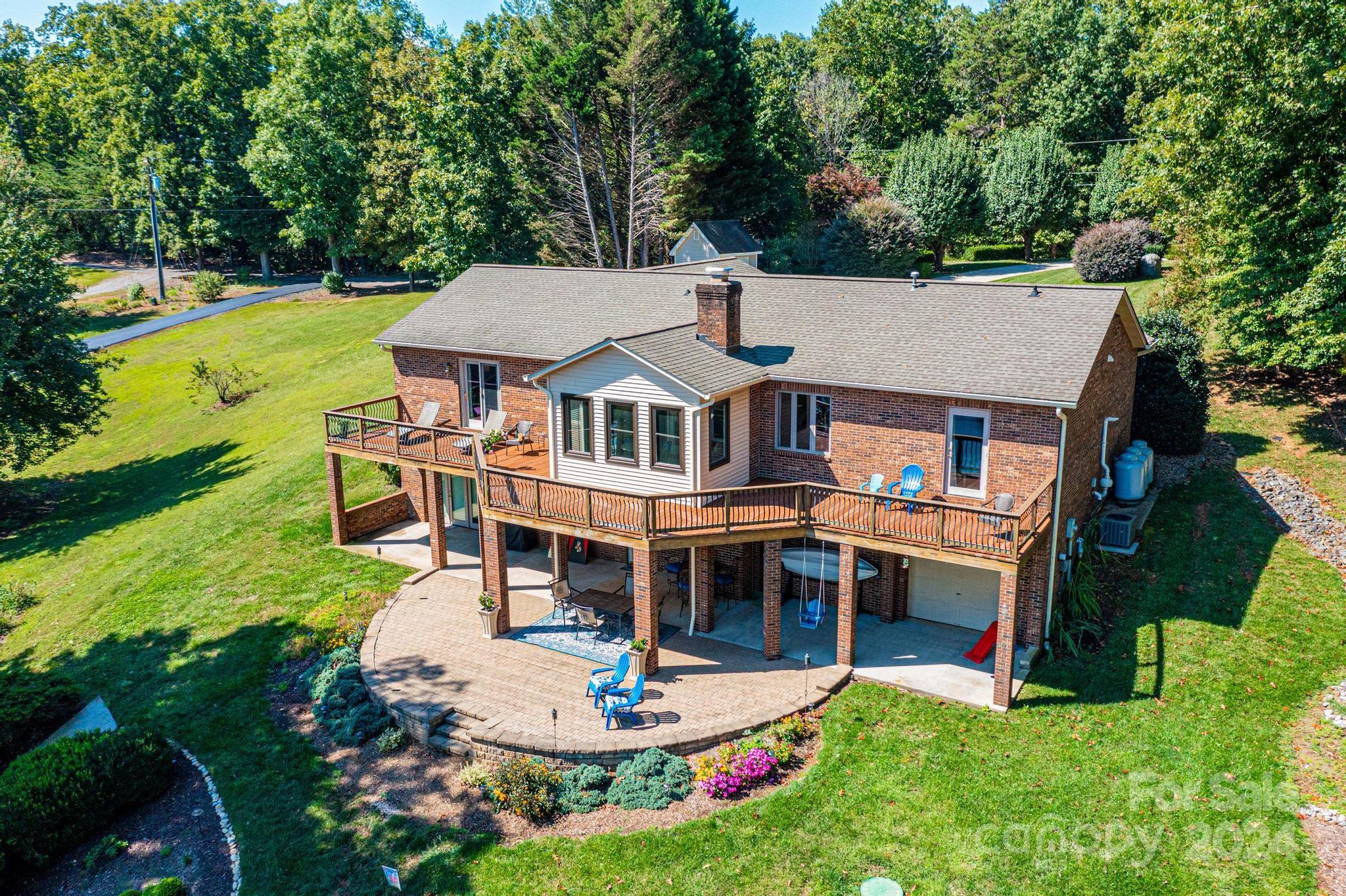 an aerial view of a house with swimming pool garden and patio