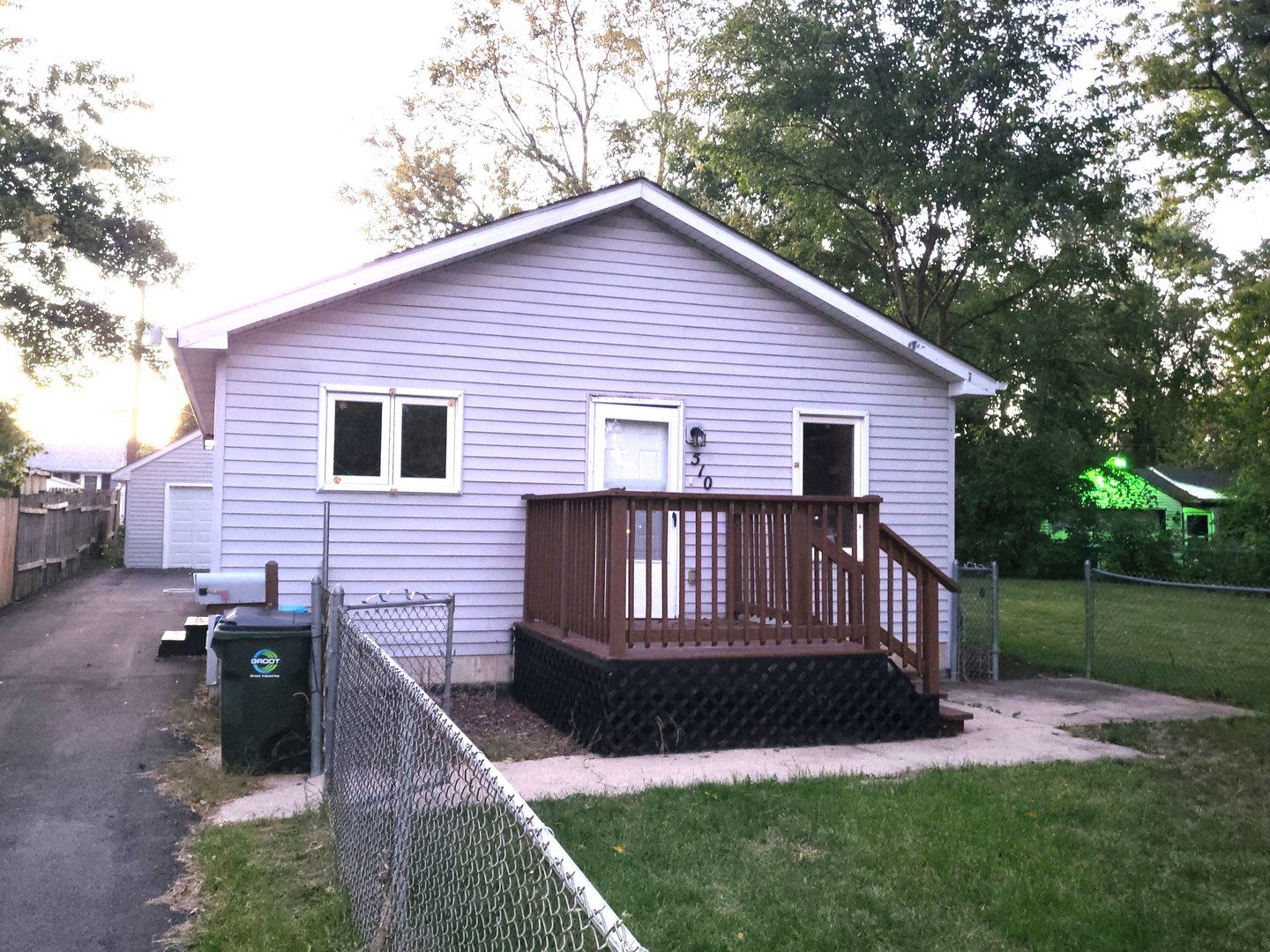 a view of a house with a yard and deck