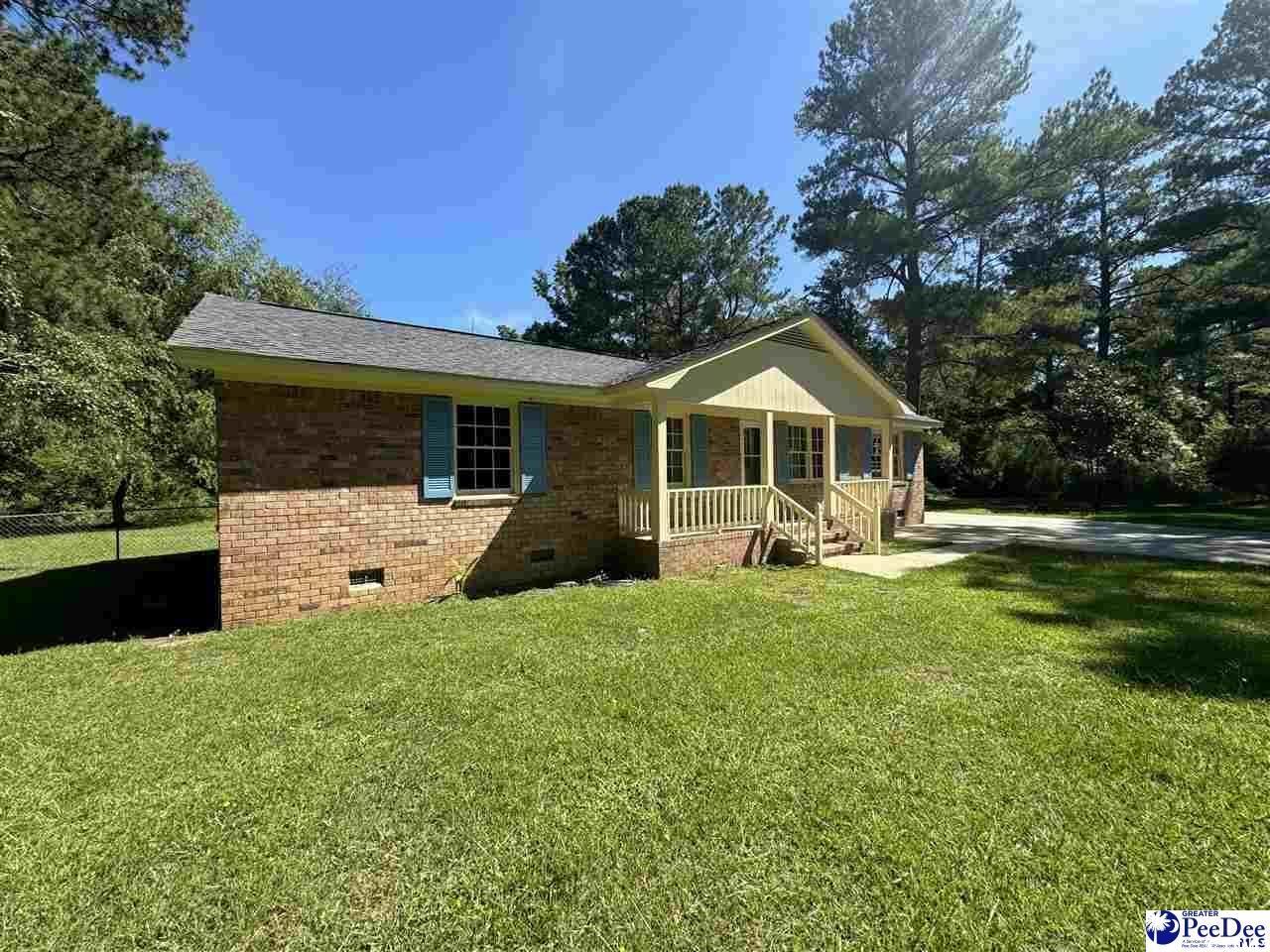 Ranch-style home featuring covered porch and a fro