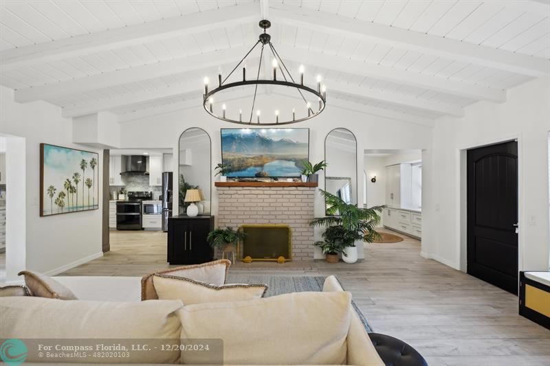 a living room with furniture a fireplace and potted plants