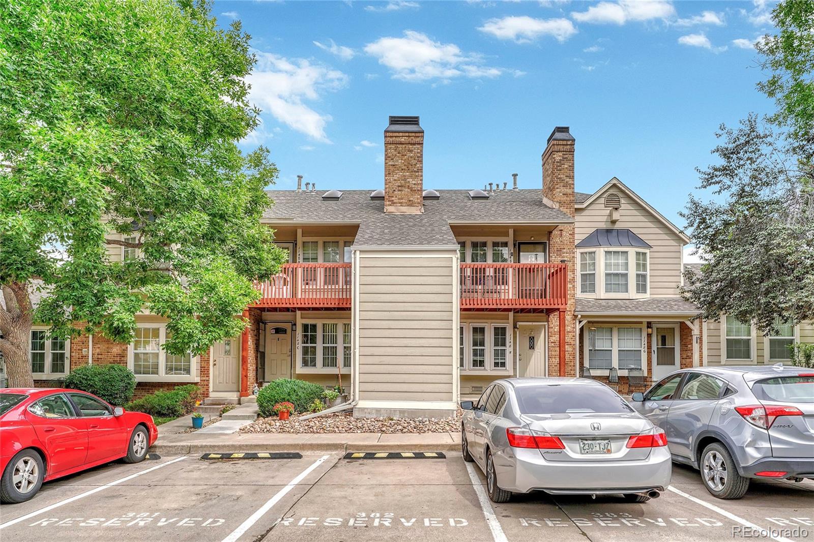 a front view of a residential apartment building with a yard