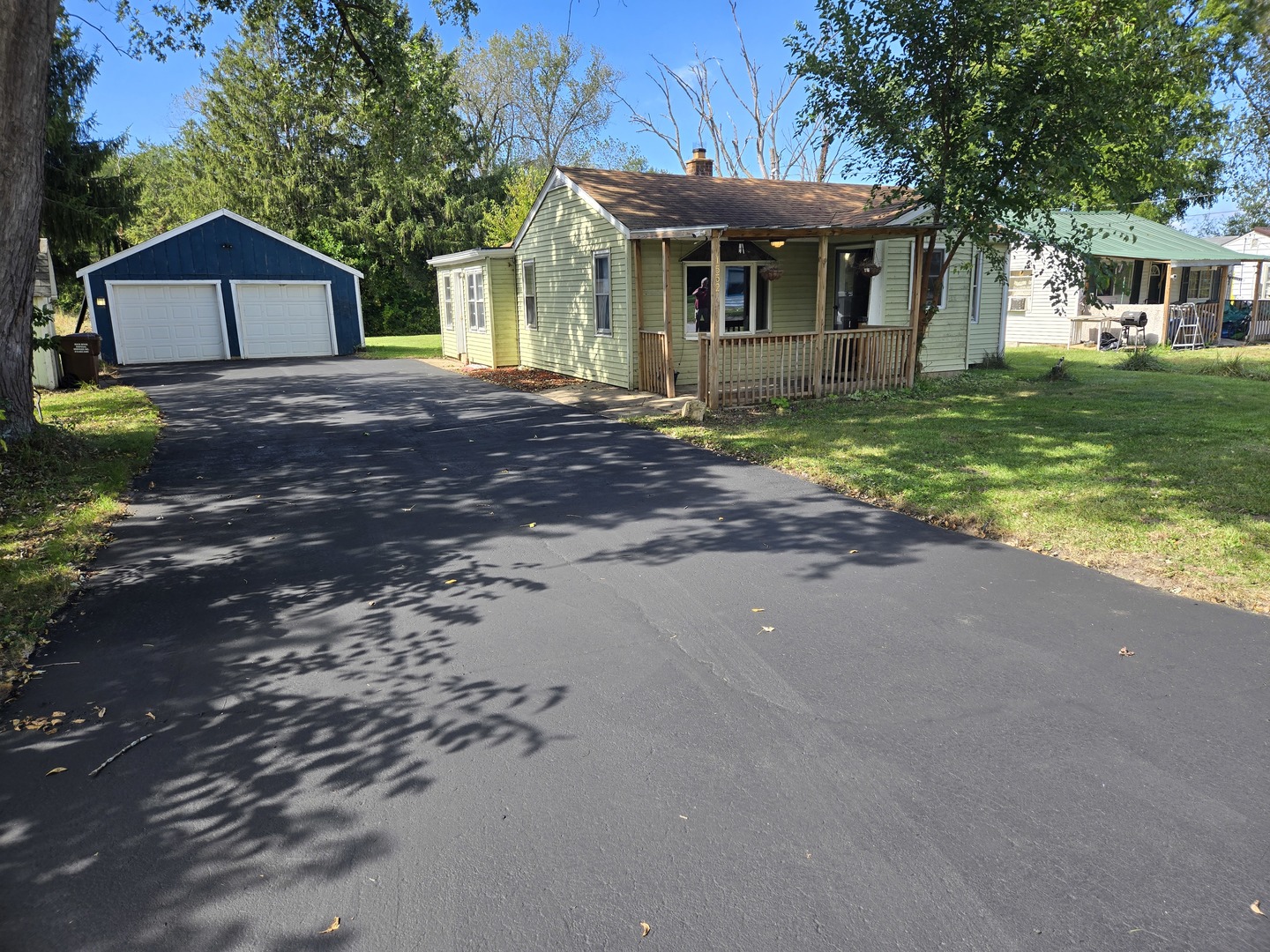 a front view of a house with a yard and trees