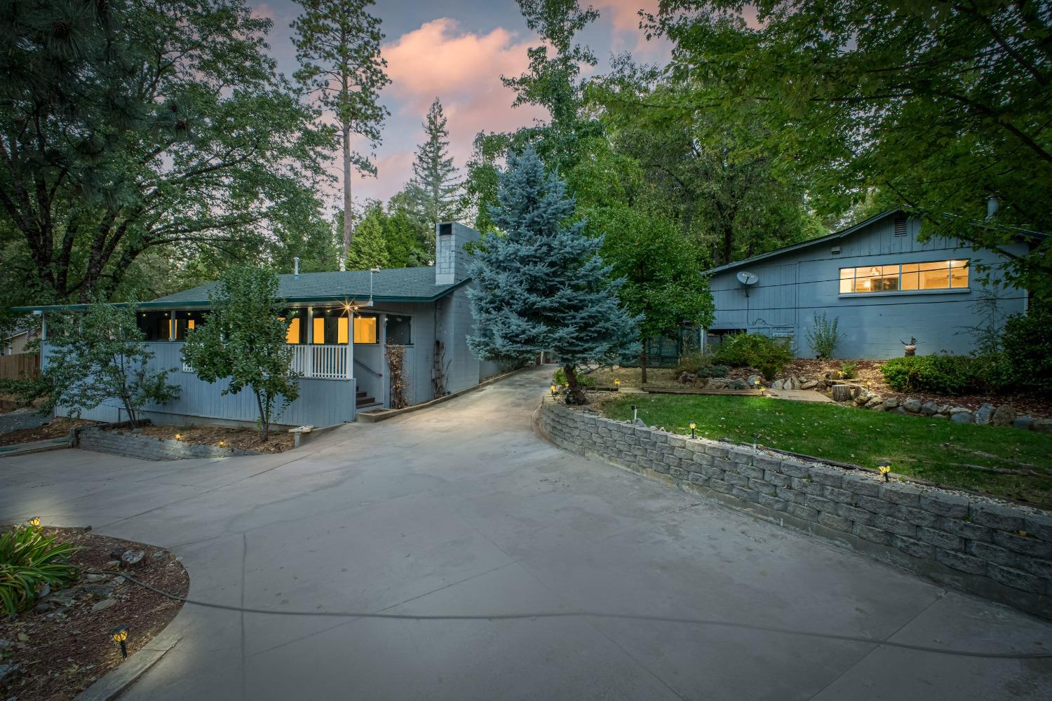 a view of a house with a yard and a garden