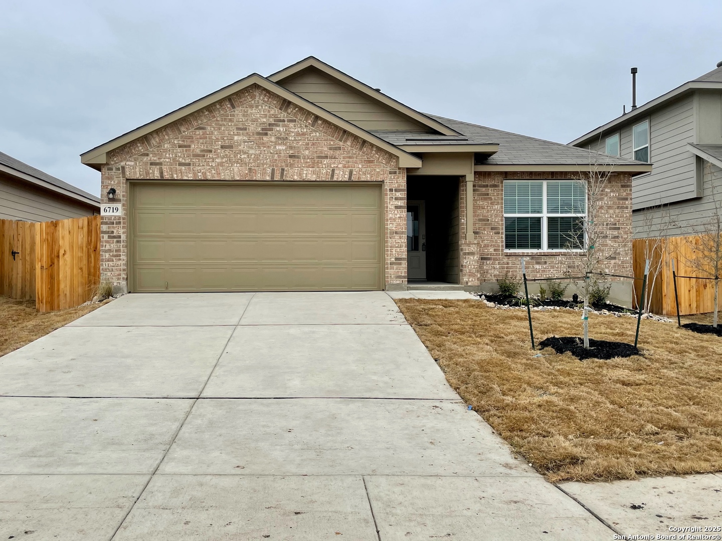 a front view of a house with yard and seating space