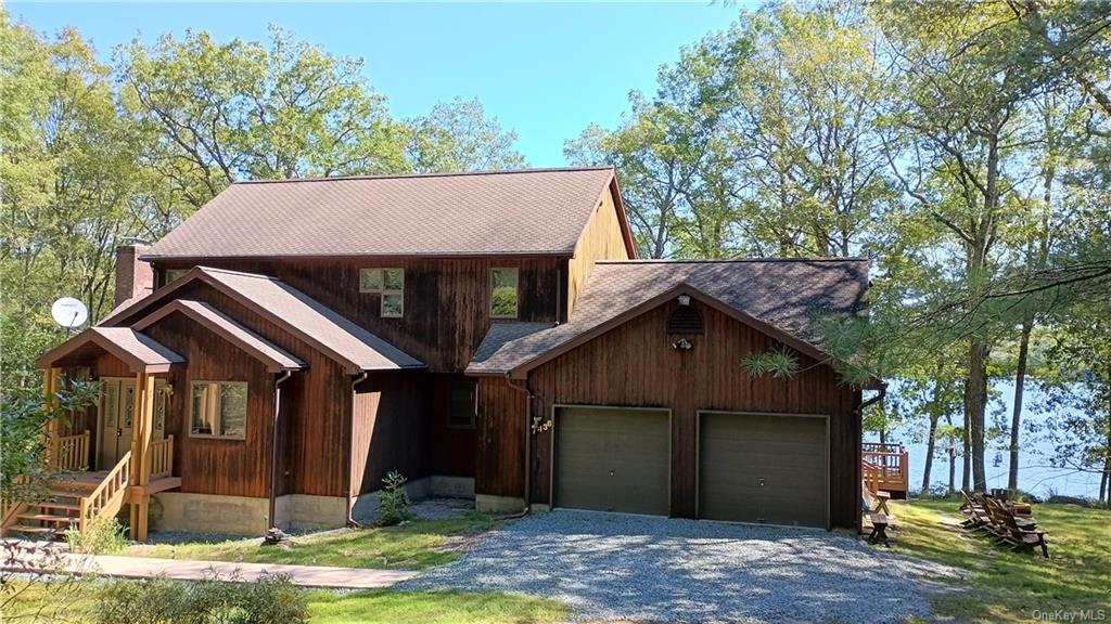 View of front of house featuring a 2 car garage and covered porch