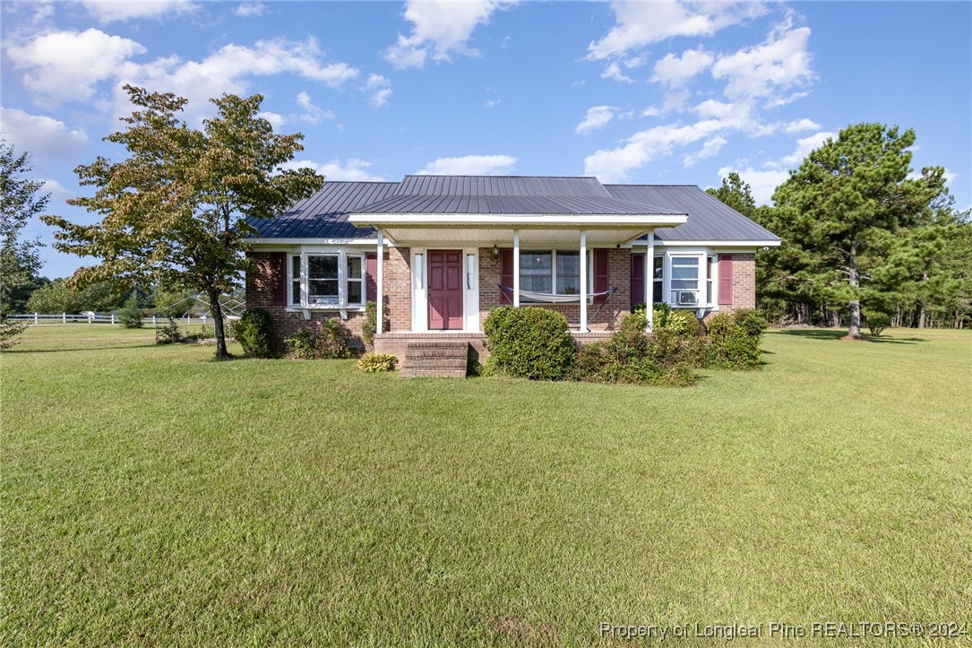 a front view of house with yard and green space