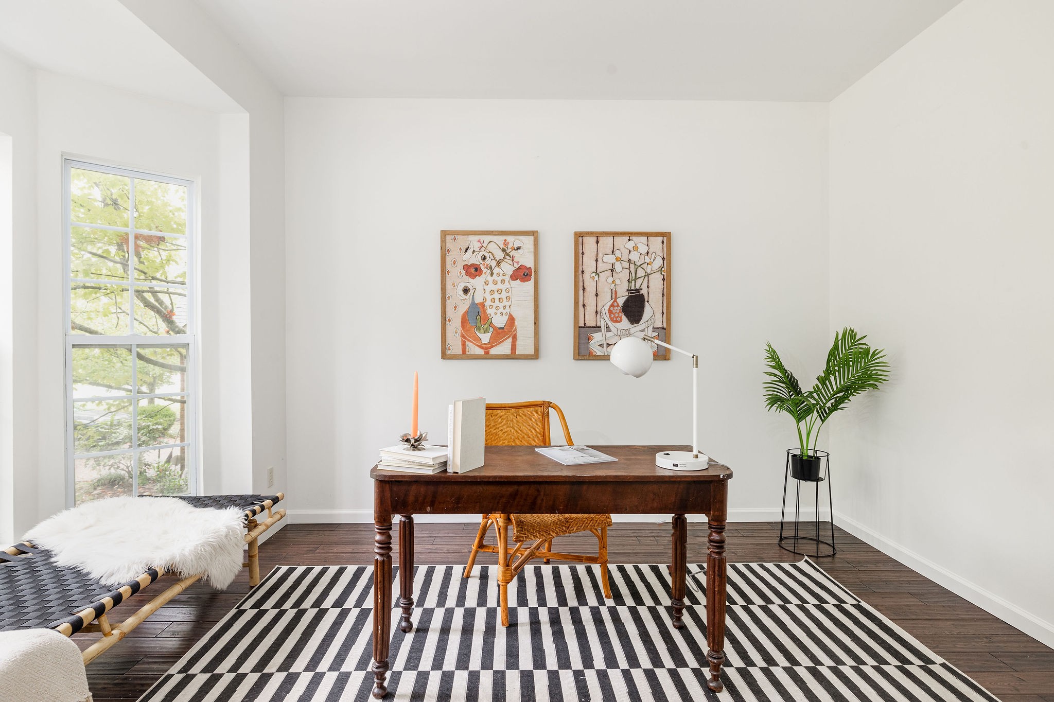 a living room with furniture and a potted plant