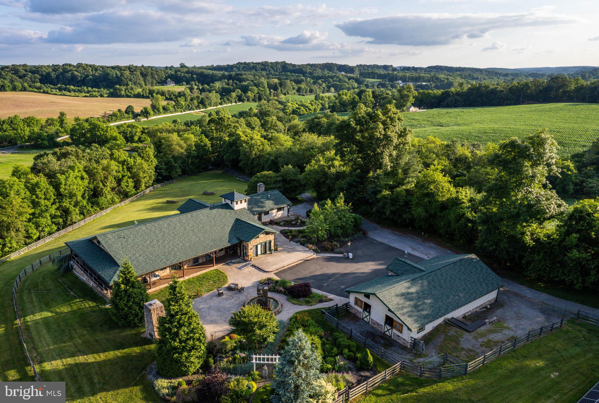 an aerial view of a house with garden space and lake view