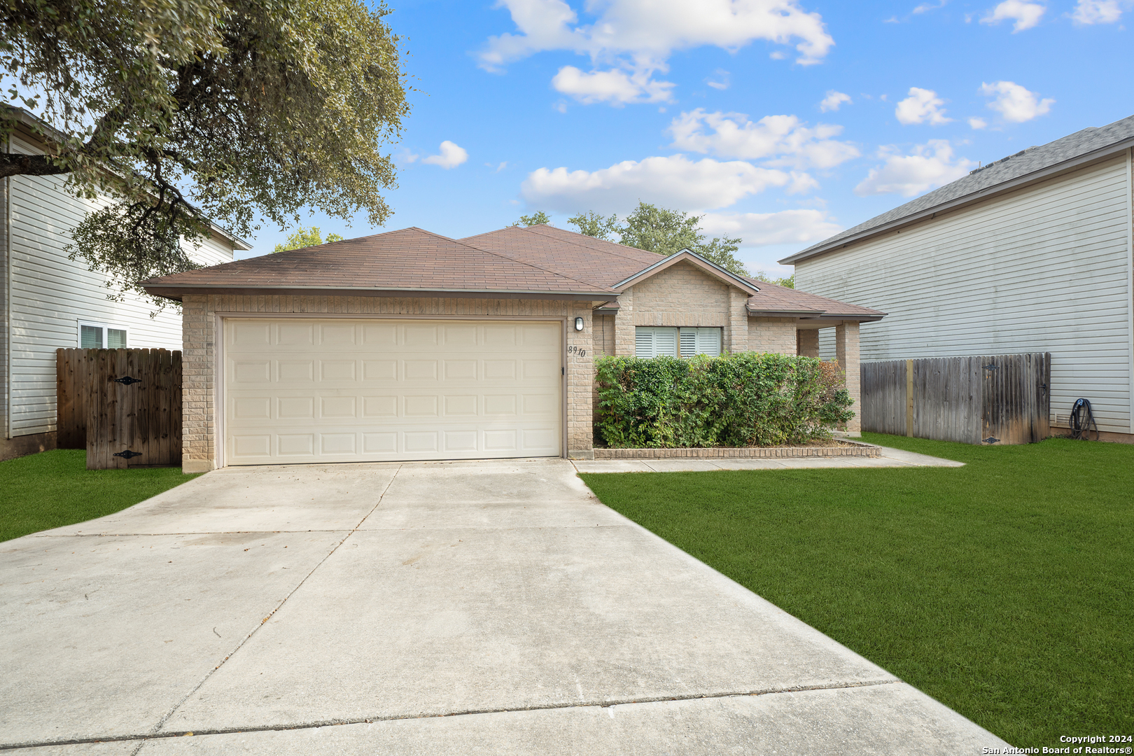 a view of backyard of house with green space