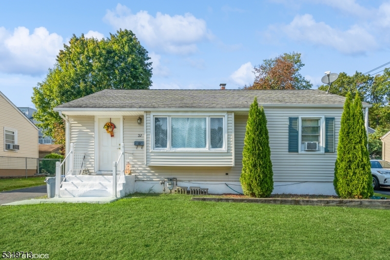 a front view of a house with a garden and yard