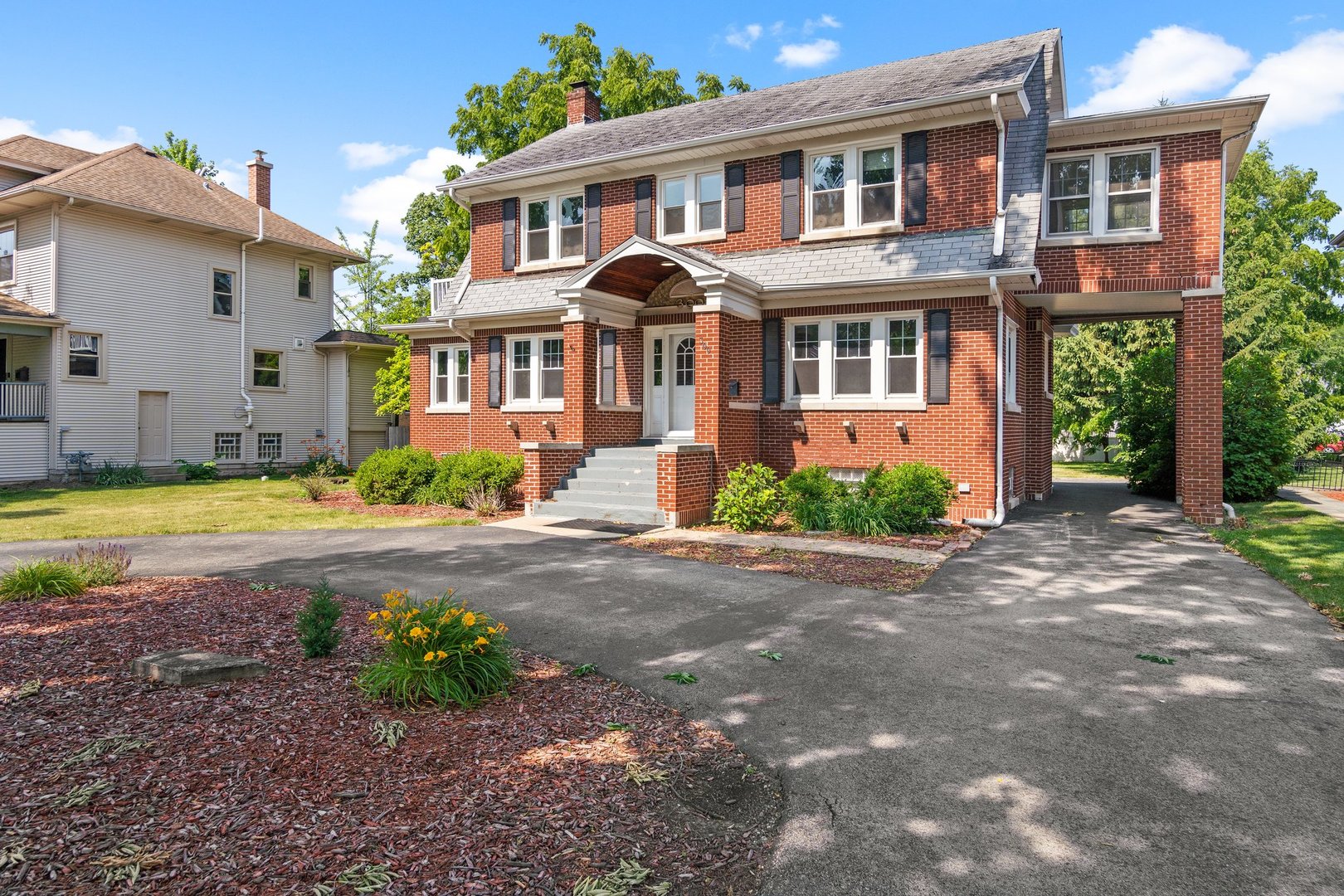 a front view of a house with garden